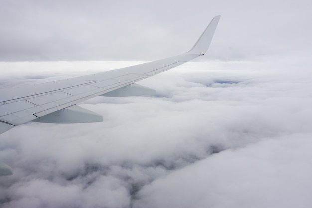 Beautiful view on the white clouds from the plane window