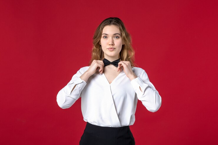 Free Photo beautiful waitress woman touching her butterfly on red background