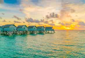 Free photo beautiful water villas in tropical maldives island at the sunset time