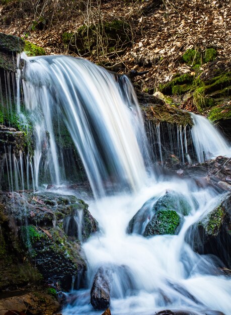 Beautiful waterfalls with mossy rocks in the forest