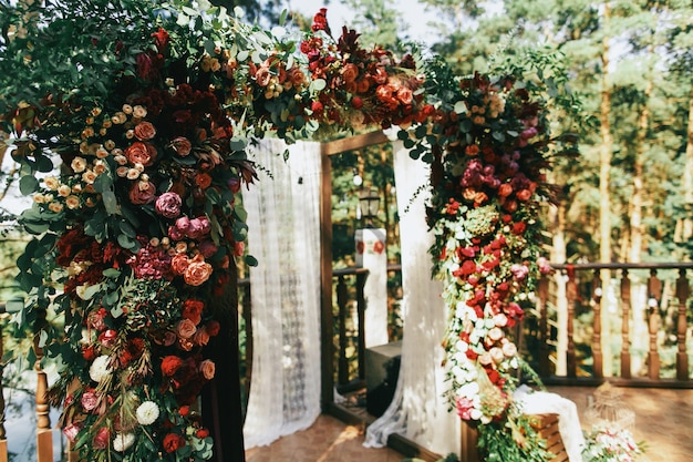 Beautiful wedding altar made of garland of spearworts and greene