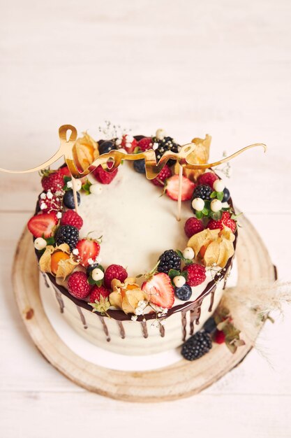 Beautiful wedding cake with fruits, chocolate drip and with Love letters