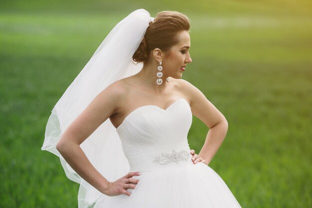 Beautiful wedding couple is walking on the green field