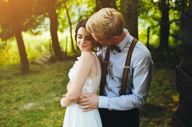 Beautiful wedding couple posing in a forest