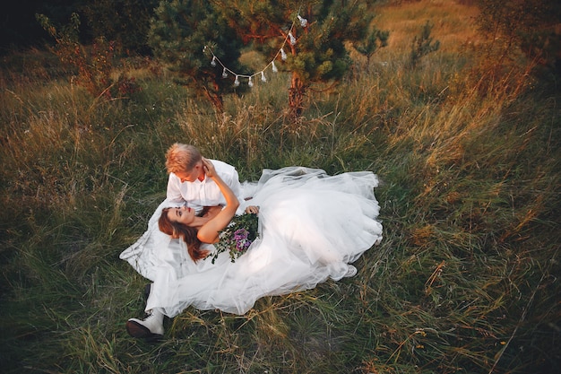 Beautiful wedding couple in a summer field