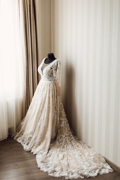 Beautiful wedding dress with plume is dressed on a mannequin