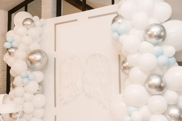 Premium Photo | Beautiful white photo zone with balloons and angel wings