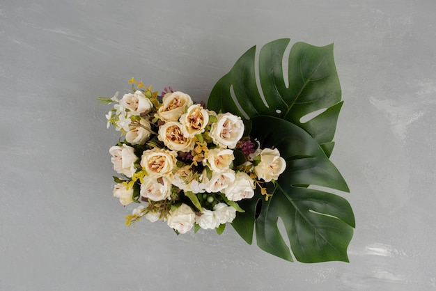 Beautiful white rose bouquet on grey surface.