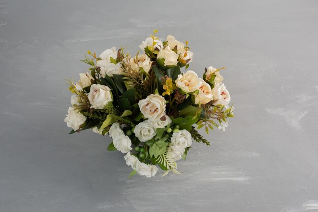 Beautiful white rose bouquet on grey table.