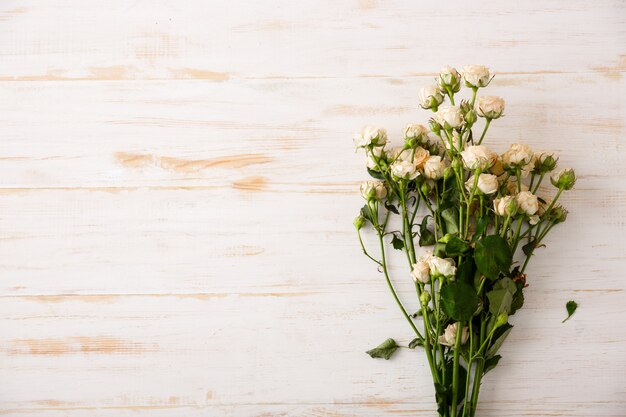 Beautiful white roses on wooden table