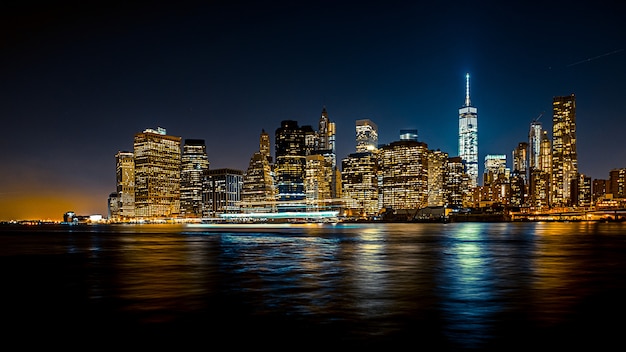 Beautiful wide shot of an urban city at night with a boat