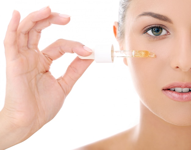 Beautiful woman applying cosmetics