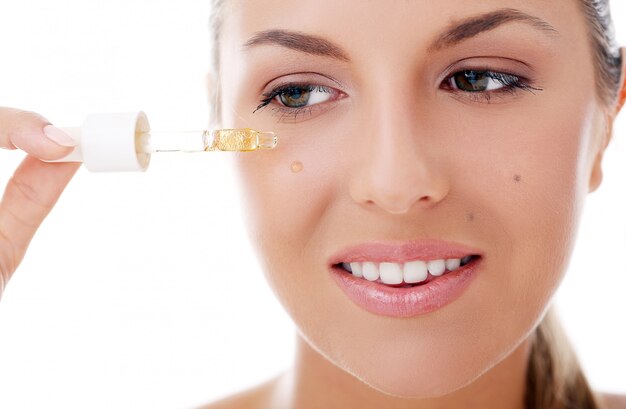 Beautiful woman applying cosmetics