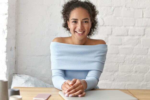 Beautiful woman at a cafe with laptop