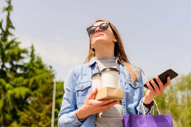 Beautiful woman carrying take away coffee