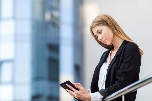 Beautiful woman checking her tablet