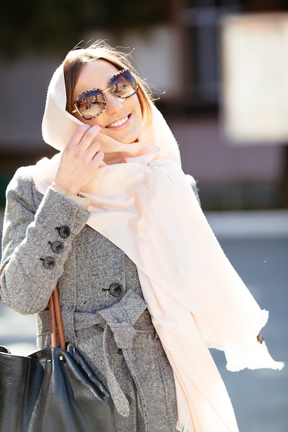 Beautiful woman in a coat posing on the street