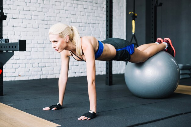 Beautiful woman doing fitball plank