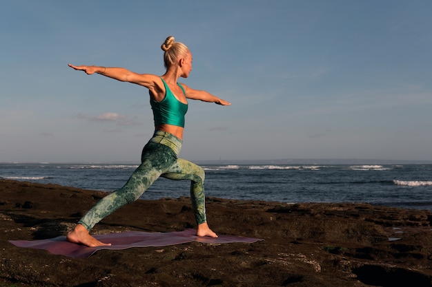 Beautiful woman doing yoga. middle plan