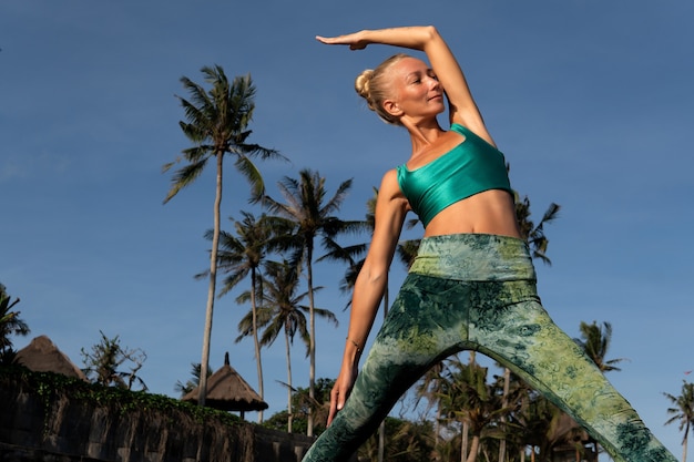 Free photo beautiful woman doing yoga. middle plan