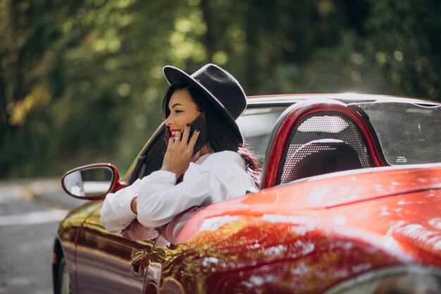 Beautiful woman driving red cabrio