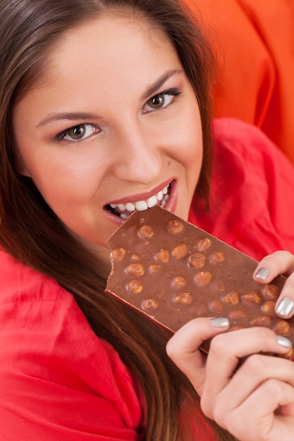 Beautiful woman eating a chocolate