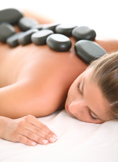 Beautiful woman enjoy spa with stones