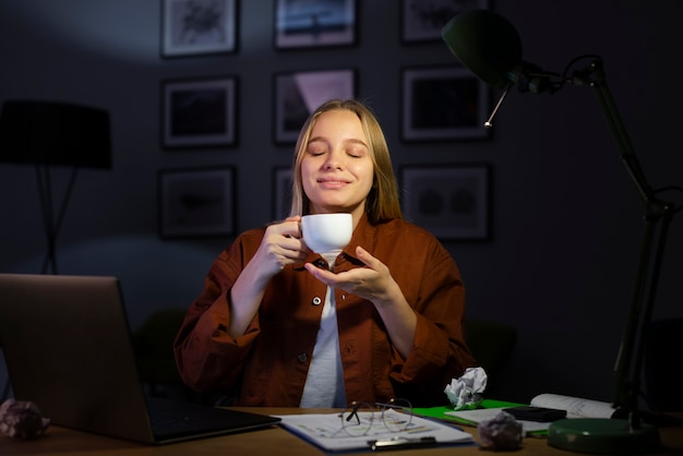 Beautiful woman enjoying coffee at desk