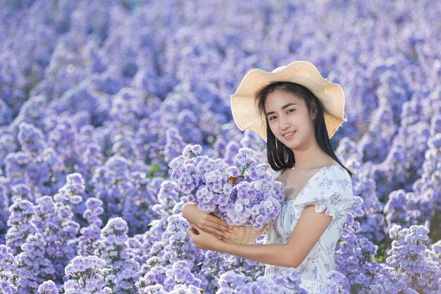 Beautiful woman enjoying flowers field