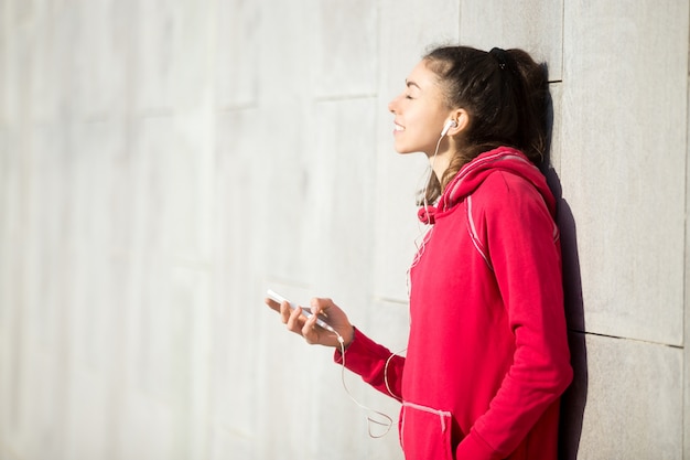 Beautiful woman enjoying music in her phone player