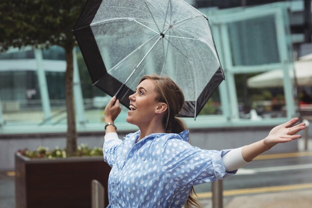 雨を楽しんでいる美しい女性