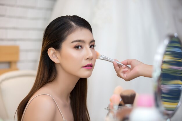 Beautiful woman face and hand of make-up
