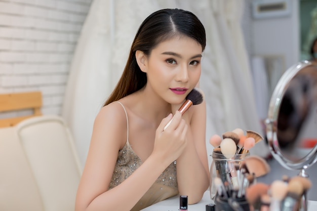 Beautiful woman face and hand of make-up