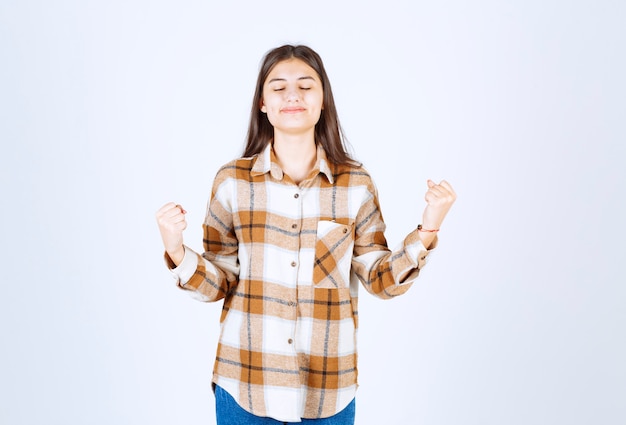 Free photo beautiful woman feeling happy on white wall.