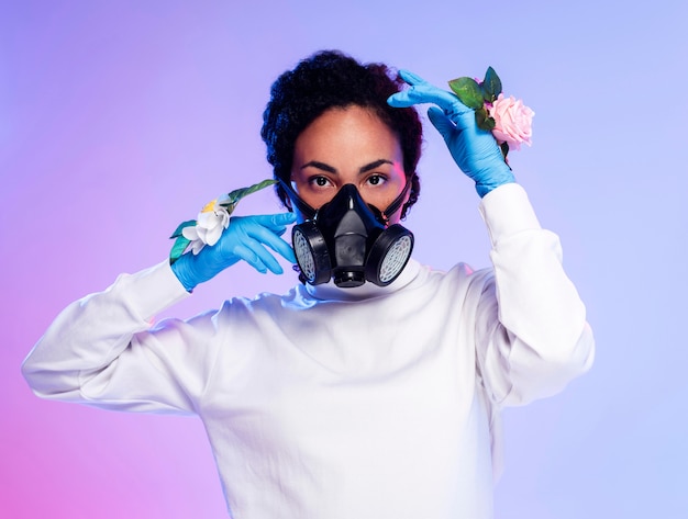 Beautiful woman in floral gloves and respiratory mask