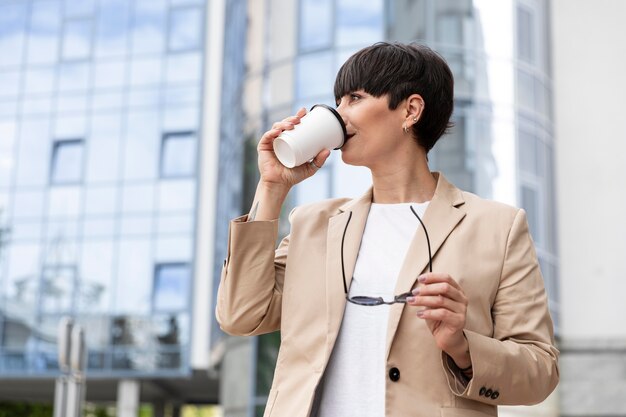 Beautiful woman in front of a glass building