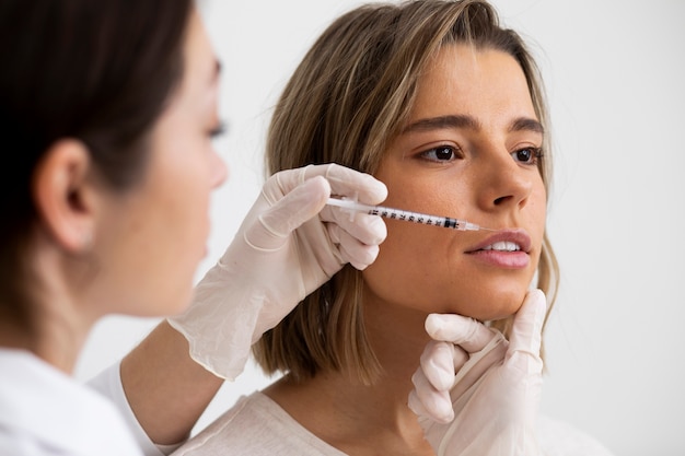 Beautiful woman getting lip filler close up