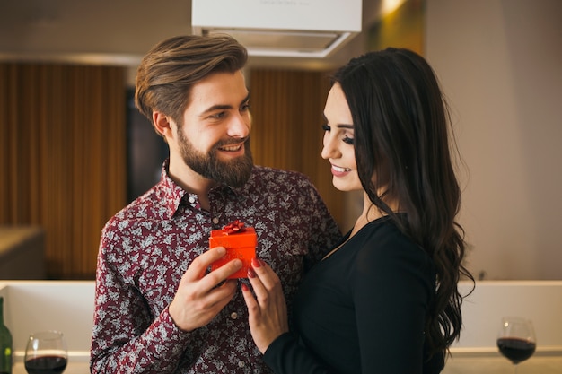 Beautiful woman getting present from man