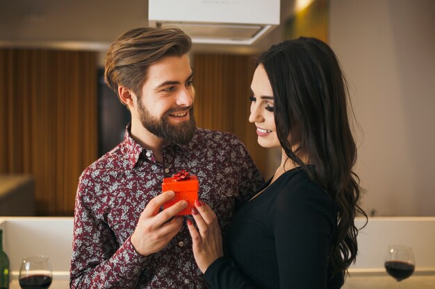 Beautiful woman getting present from man