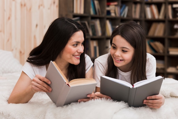 Free photo beautiful woman and girl reading books