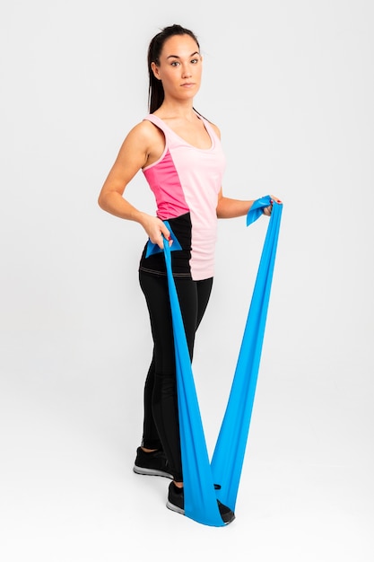 Beautiful woman at gym stretching arms exercise