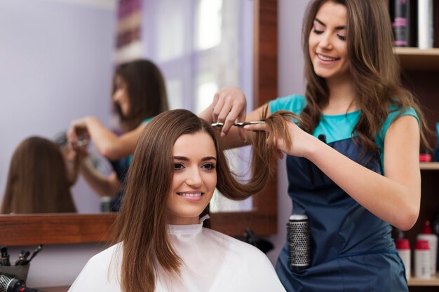 Beautiful woman has cutting hair at the hairdresser