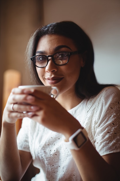 Beautiful woman having a cup of coffee in café