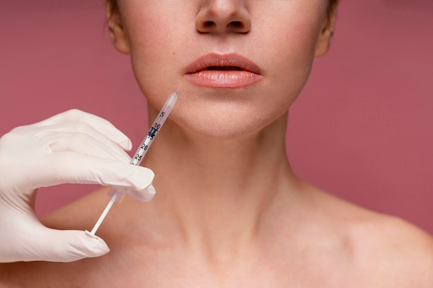 Free photo beautiful woman having her face injected