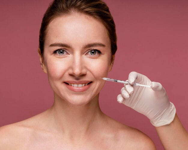 Beautiful woman having her face injected