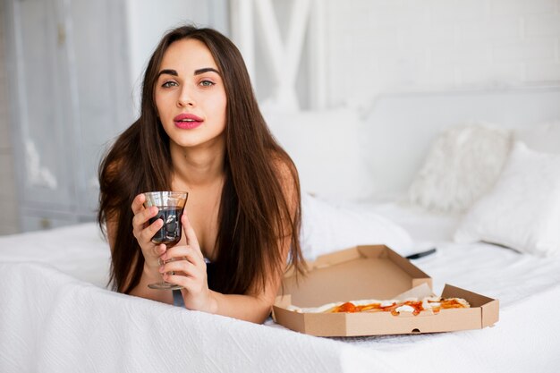 Beautiful woman having pizza snack and wine