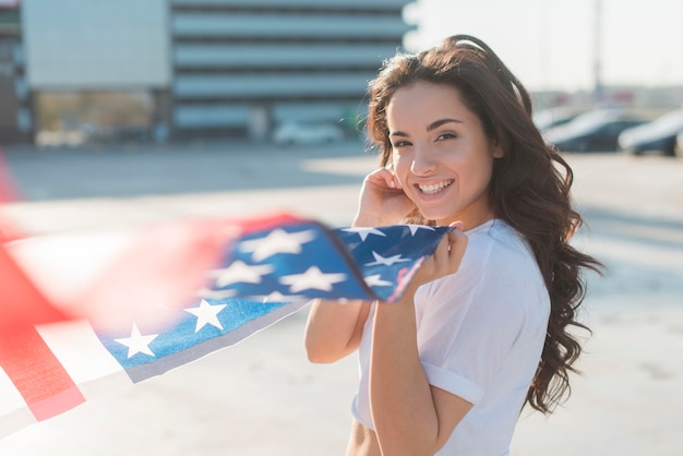 Free photo beautiful woman holding big usa flag