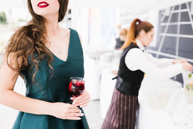 Beautiful woman holding glass with alcohol