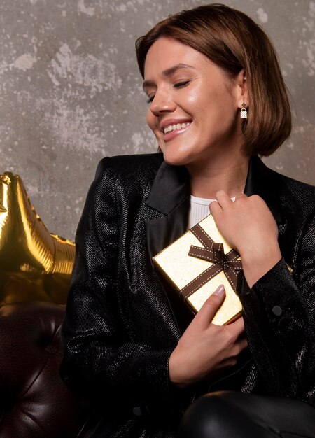 Beautiful woman holding new year's eve present