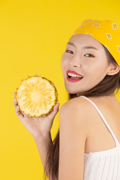 Beautiful woman holding a pineapple